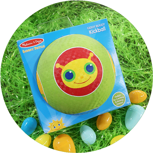 A green plastic kickball with an image of a yellow and red caterpiller on it, surrounded by green easter grass and colorful easter eggs.